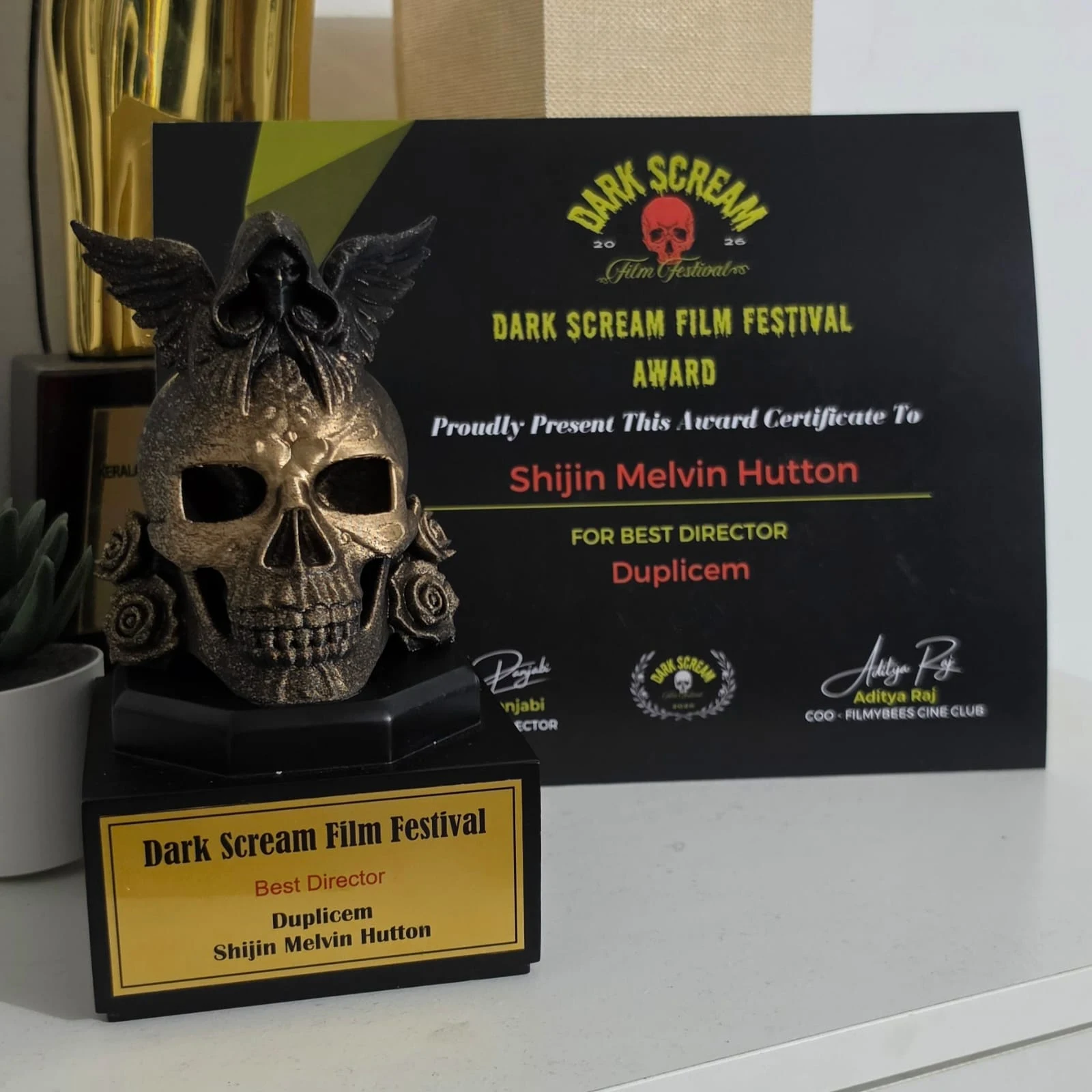 The Dark Scream Film Festival Best Director trophy and certificate for Duplicem, awarded to Shijin Melvin Hutton.